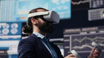 Leader does data driven planning with VR device set for successful strategy to ensure global expansion and growth. Using graphs on 3d simulation to guide performance ideas. Camera A. video