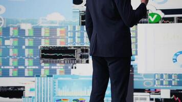 Expert businessman on a smartphone call discussing finance and analytics, building a corporate strategy. Surrounded by data charts, planning digital innovation and company growth. Camera B. video