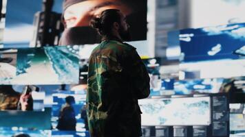 Military personnel examines data from satellite and creates tactical operations, control center for a mission. Soldier uses threat detection systems and tools for national interests. Camera A. video