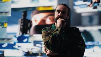 Military soldier satisfied with data collected from surveillance footage, working on tactical operations in high tech command center. Personnel protecting national interests. Camera A. video