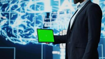 Studying neural networks systems, young IT specialist implements artificial intelligence with mockup screen on tablet. Man using automation for modern AI strategy and innovation. Camera A. video