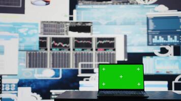 In a business related space, laptop display shows green screen to help with strategy planning with financial data. Representing modern artificial intelligence and productivity for growth. Camera B. video