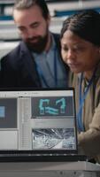 Vertical Group of industry experts engineers examining solar panel systems during a production inspection, ensuring engineering accuracy, quality control and factory operations efficiency. Camera A. video