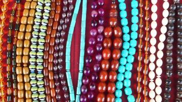 Colorful bead display at local market in sunny afternoon video