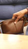 Stylish brown handbag displayed on a table surface video
