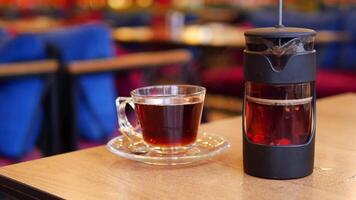 Enjoying warm tea at a cozy cafe in autumn video