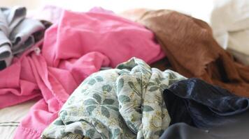 Sorting colorful fabric piles in a bright room environment video