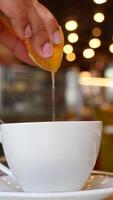 Squeezing citrus into a warm beverage at local cafe video