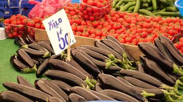 Buying fresh vegetables at local market in vibrant setting video