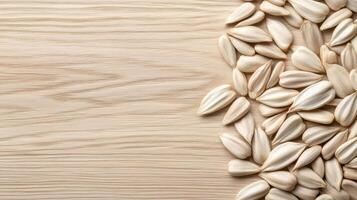 Sunflower Seeds Pile on Wooden Surface. White Seed Shells Grouped for Planting in Gardening. Natural Farming Product Concept on Table. photo
