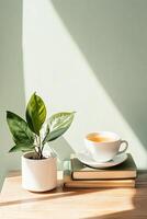 Small Plant Growing in Pot Near Cup of Tea on Books with Light on a Wooden Table, Simple Peaceful Indoor Setting photo