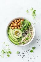 Healthy Bowl with Chickpeas Avocado Quinoa and Sprouts on Bright Table. Balanced Meal for Health and Fitness. Organic Diet for Wellness. photo