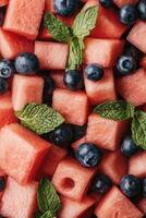 Diced Watermelon Fruit with Blueberries and Mint Leaves Displayed for Health and Fitness photo