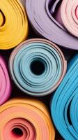 Rolled colorful mats. Fitness training equipment. Studio setting. Abstract texture. Health and Fitness. photo