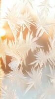 Winter frost patterns cover glass surface. Sunlight glow behind icy designs. Delicate, intricate ice crystals form unique, natural artwork. Cold season texture for backgrounds. photo