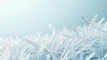 Delicate ice crystals forming. Sharp frozen shapes. Blue tinted background. Winter season details. Cold temperature. Sparkling crystalline texture. photo