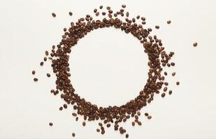 Empty circle drawn with coffee beans on white isolated background. Mockup for advertizing, copy space for text, top view photo