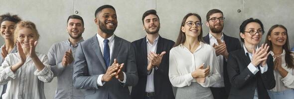 Happy business team applauding after successful group meeting, panorama photo