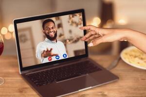 Long Distance Relationship. African american couple having online virtual date, reaching hands to each other to webcam in videochat with videoconferencing app window. Remote Dating During Pandemic. photo