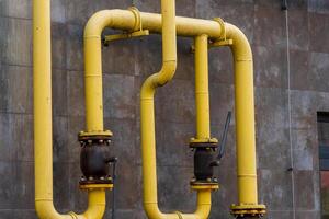 Intricate network of yellow pipelines showcases energy transportation technologies. This industrial setup features metal tubes connecting to valves, emphasizing efficiency in powering infrastructure photo