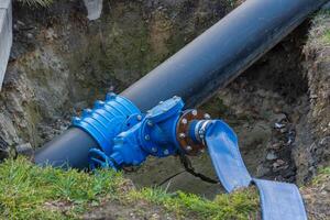 Workers are engaged in the crucial task of repairing a large water pipeline at a construction site photo