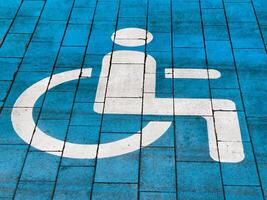 A designated parking space features a clear wheelchair symbol on a blue background, indicating accessibility for individuals with disabilities. This space is essential for inclusive transport options photo