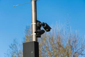 This setup features several CCTV cameras affixed to a pole, monitoring the surroundings in an effort to increase safety and security in a public space under bright daylight photo