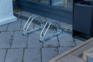 Secure bicycle parking available with metal racks positioned outside a retail area. The setting is calm and organized, suitable for cyclists visiting nearby stores photo