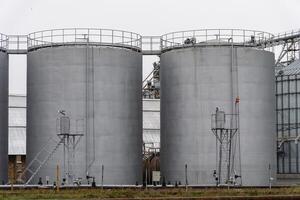 Large fuel storage tanks stand side by side in an industrial setting, utilized for storing various fuels. The structures highlight the importance of energy resources photo