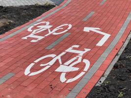 Brightly colored bike lane signs delineate a dedicated cycling path, ensuring safety for cyclists navigating the newly constructed bike route in the city photo
