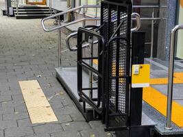 The entrance showcases a well-designed wheelchair ramp complemented by clear signage, ensuring easy access for individuals with mobility challenges photo