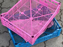 Brightly colored crates are stacked, showcasing a lively market filled with various products. The atmosphere is vibrant and busy, reflecting a bustling trade environment photo