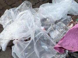 Various pieces of discarded plastic and debris are scattered on the pavement, emphasizing the pressing issues of urban pollution and waste accumulation in public spaces photo