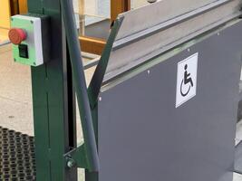 A well-designed accessible entrance includes a wheelchair ramp and clear signage, ensuring easy access for everyone in a busy urban setting photo