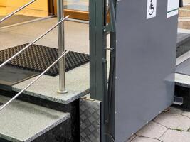 A sleek, metallic ramp stands ready by a set of stairs, designed for those with mobility impairments, promoting inclusivity and accessibility for all photo