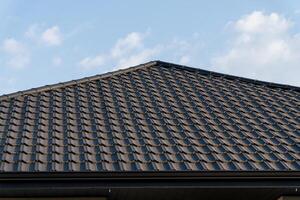 A beautifully crafted rooftop features intricate tile patterns under a clear blue sky, inviting warmth and tranquility from the gentle sunshine photo