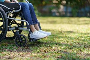 a person sitting in a wheelchair on the grass photo