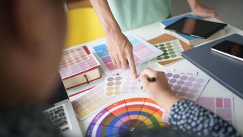 a person is working on a computer with a color wheel Teamwork brainstorming photo