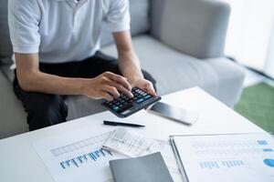 a man is using a calculator financal on a table photo