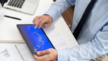 a man is using a tablet computer with a chart on it photo