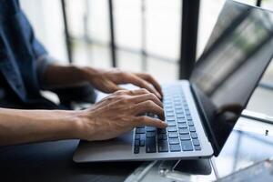 IT engineer typing on a laptop computer photo