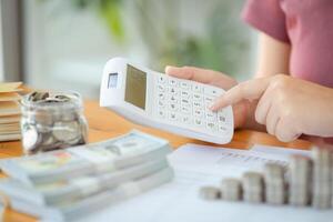 a woman is using a calculator to calculate the amount of money photo