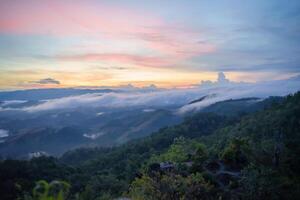 a view of a mountain range with a sunset photo