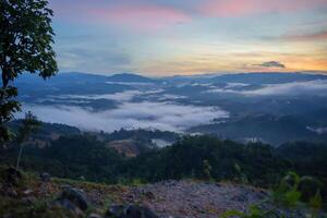 a view of a nature with clouds and trees photo