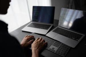 software engineer coding on a laptop computer photo