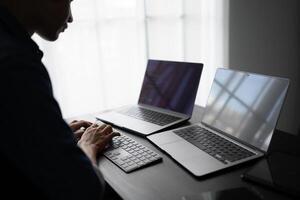 software engineer Working on Computer at office desk for writing program code IT Software Engineer finding errors tech support devops creating digital photo