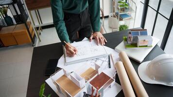 architectural design concept, architect and engineer working on architectural design concept, man in green shirt photo