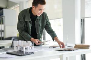 Architecture Man is working on a project in an office photo