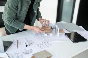 Architecture interior is working on a model of a house in office photo