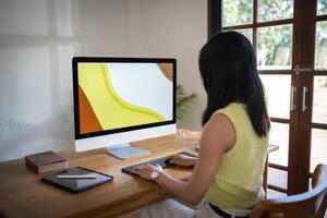 Graphic designer working on digital tablet and computer. Designer Asian Woman artist drawing on graphic tablet Artist Creative Designer sketch graphic drawing creative in office. photo